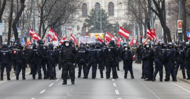 Police stops the demonstration march against the country's coronavirus restrictions around the "Vienna Ring" in Vienna, Austria, Jan. 8, 2022. (AP Photo/Lisa Leutner)