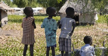 Children look out across the community of Old Fangak in Jonglei state, South Sudan, Dec. 28, 2021. (AP Photo)