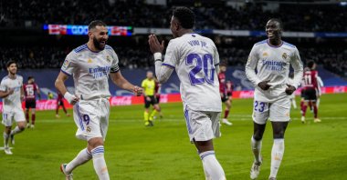 Real Madrid's Vinicius Junior (C) is congratulated by teammate Karim Benzema (L) after scoring a goal in La Liga match against Valencia, Madrid, Spain, Jan. 8, 2022. (AP Photo)