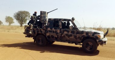 Nigerian soldiers drive past Government Science secondary school in Kankara, Nigeria, Dec. 16, 2020. (AP Photo)
