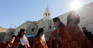 Members of the clergy gather as the Greek Orthodox Patriarch of Jerusalem Theophilos III arrives at the Church of the Nativity to celebrate Christmas according to the Eastern Orthodox calendar, in Bethlehem in the Israeli-occupied West Bank, Palestine, Jan. 6, 2022. (Reuters Photo)