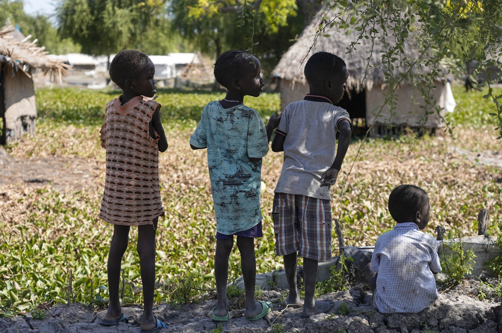 Children look out across the community of Old Fangak in Jonglei state, South Sudan, Dec. 28, 2021. (AP Photo)