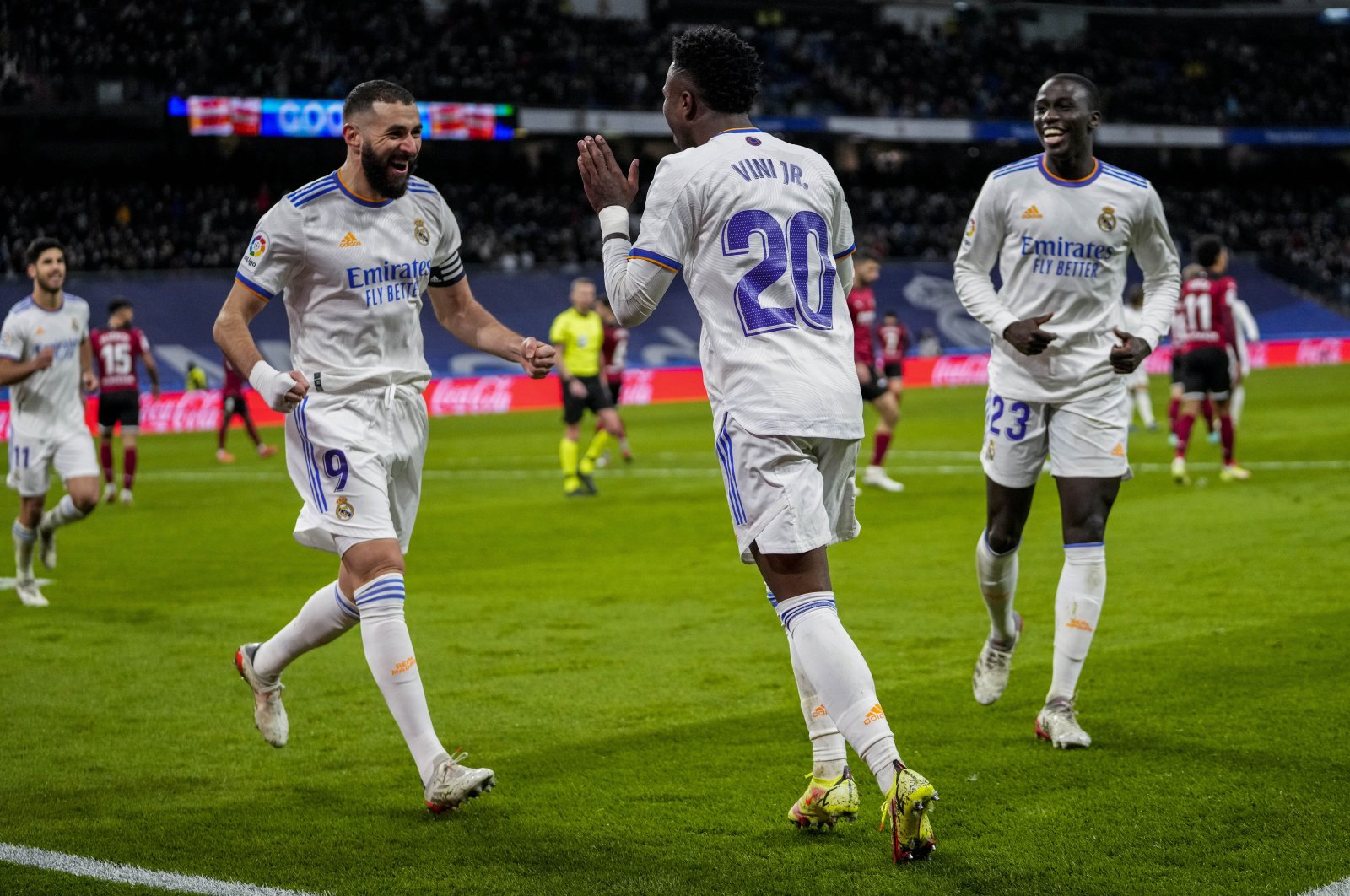 Real Madrid&#039;s Vinicius Junior (C) is congratulated by teammate Karim Benzema (L) after scoring a goal in La Liga match against Valencia, Madrid, Spain, Jan. 8, 2022. (AP Photo)