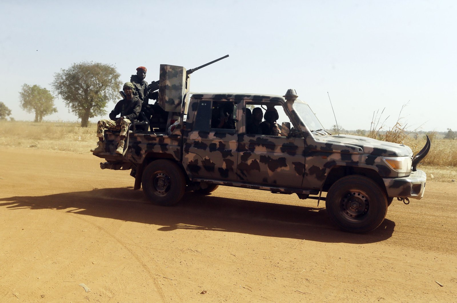Nigerian soldiers drive past Government Science secondary school in Kankara, Nigeria, Dec. 16, 2020. (AP Photo)