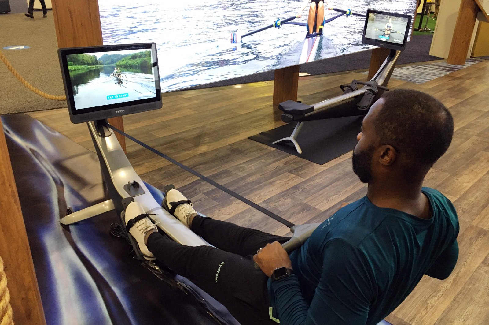 Aquil Abdullah, an employee of the Hydrow rowing fitness company, demonstrates a rowing machine at the CES technology show in Las Vegas, U.S., Jan. 7, 2022. (AFP Photo)