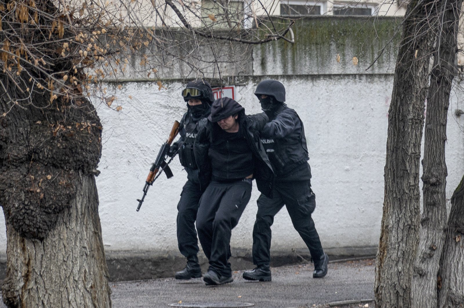 Armed riot police officers detain a protester during a security operation in a street after clashes in Almaty, Kazakhstan, Jan. 8, 2022. (AP Photo)