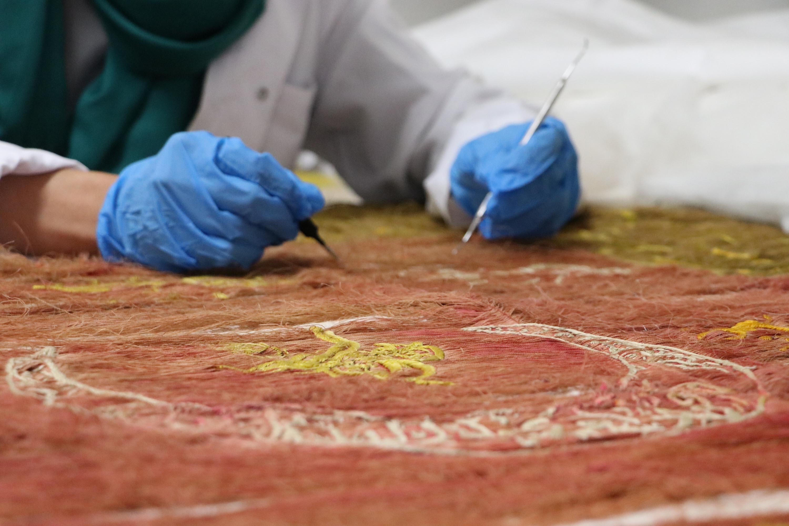 A restorer works on an 18th century flag sent from the Amasya Museum, Ankara, Turkey, January 9, 2022. (DHA Photo)