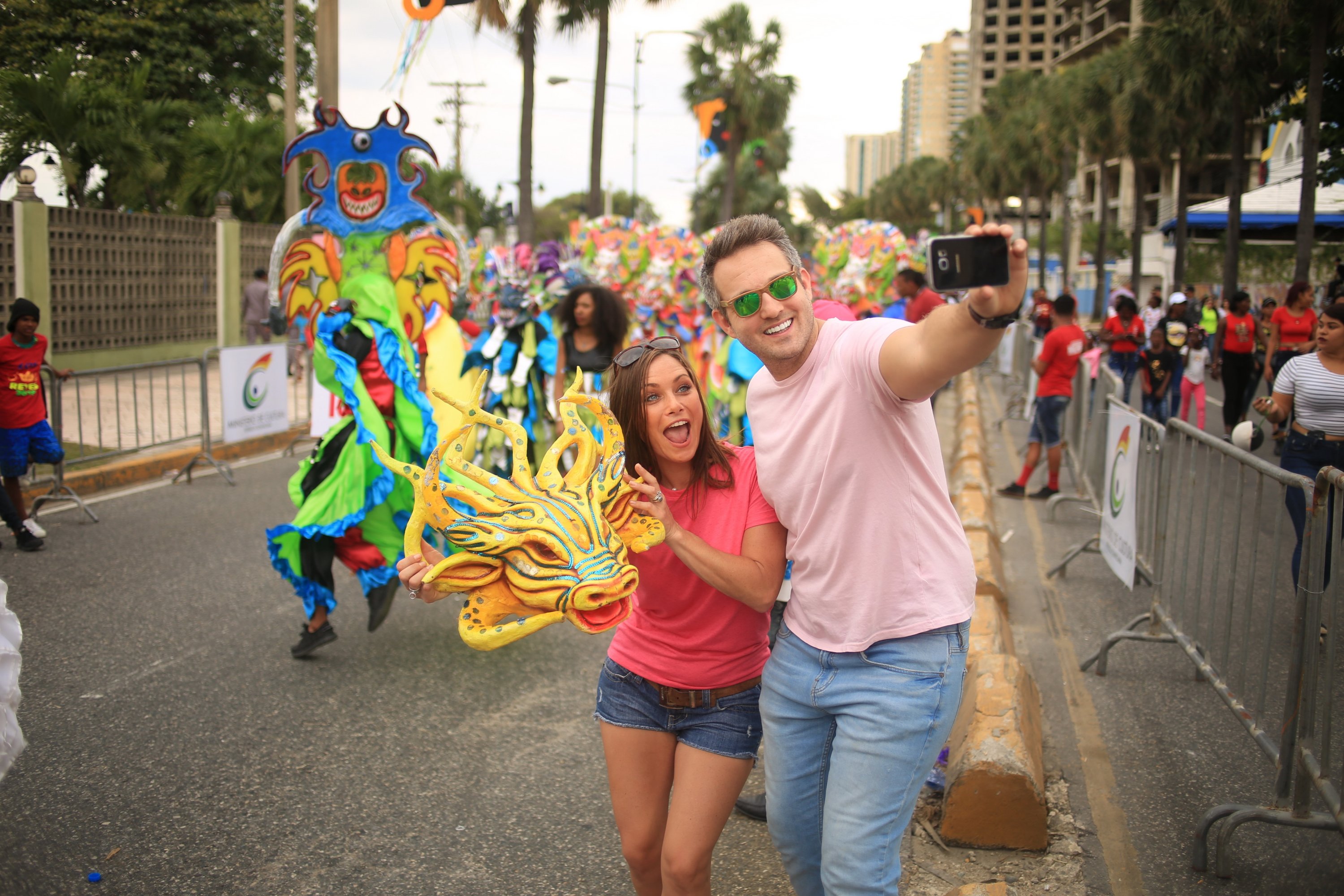 Tourists take a selfie with dragon head at the carnival in the Dominican Republic, Dec. 17, 2019. (DPA)