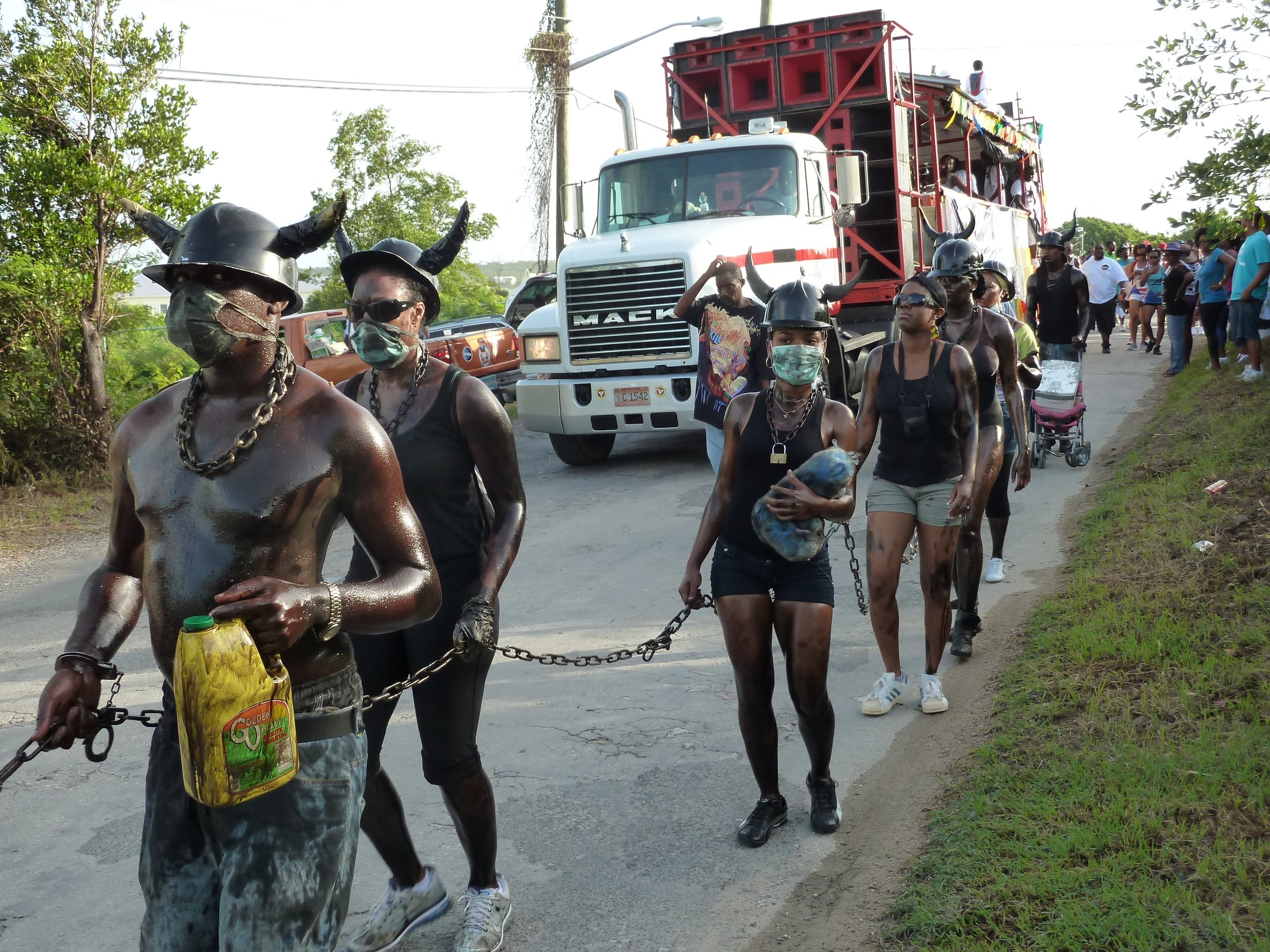 People oiled in black and in chains, recall the suffering of the slave era at the Street Jam in Anguilla. (DPA)