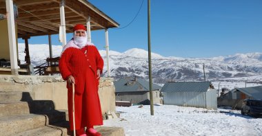 Woman in red, Nafiye Caz, posing on the stairs, Bingöl, Turkey, Jan. 10, 2022. (AA Photo)