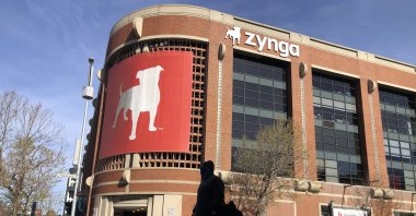 A pedestrian walks in front of a sign at Zynga in San Francisco, U.S., March 16, 2021. (AP Photo)