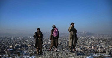 Members of the Taliban stand over a plinth overlooking Kabul city at the Wazir Akbar Khan hill in Kabul, Afghanistan, Jan. 10, 2022. (AFP)