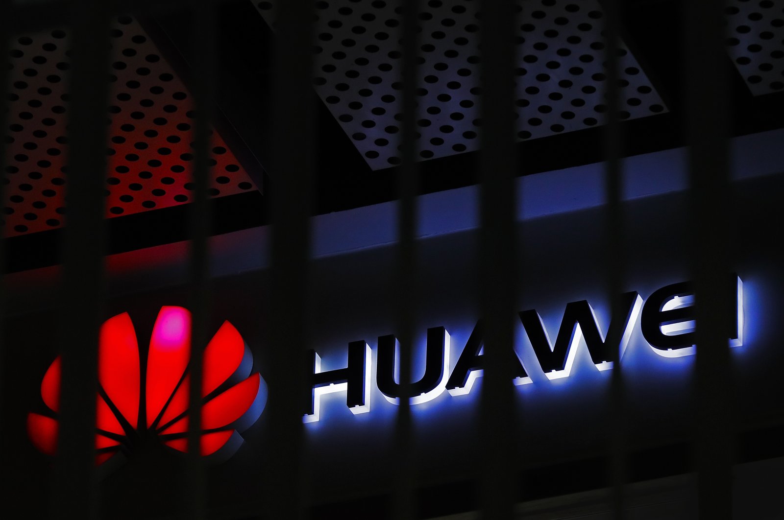 The logo of a Huawei retail shop is seen through a handrail inside a commercial office building in Beijing, China, March 8, 2019. (AP Photo)