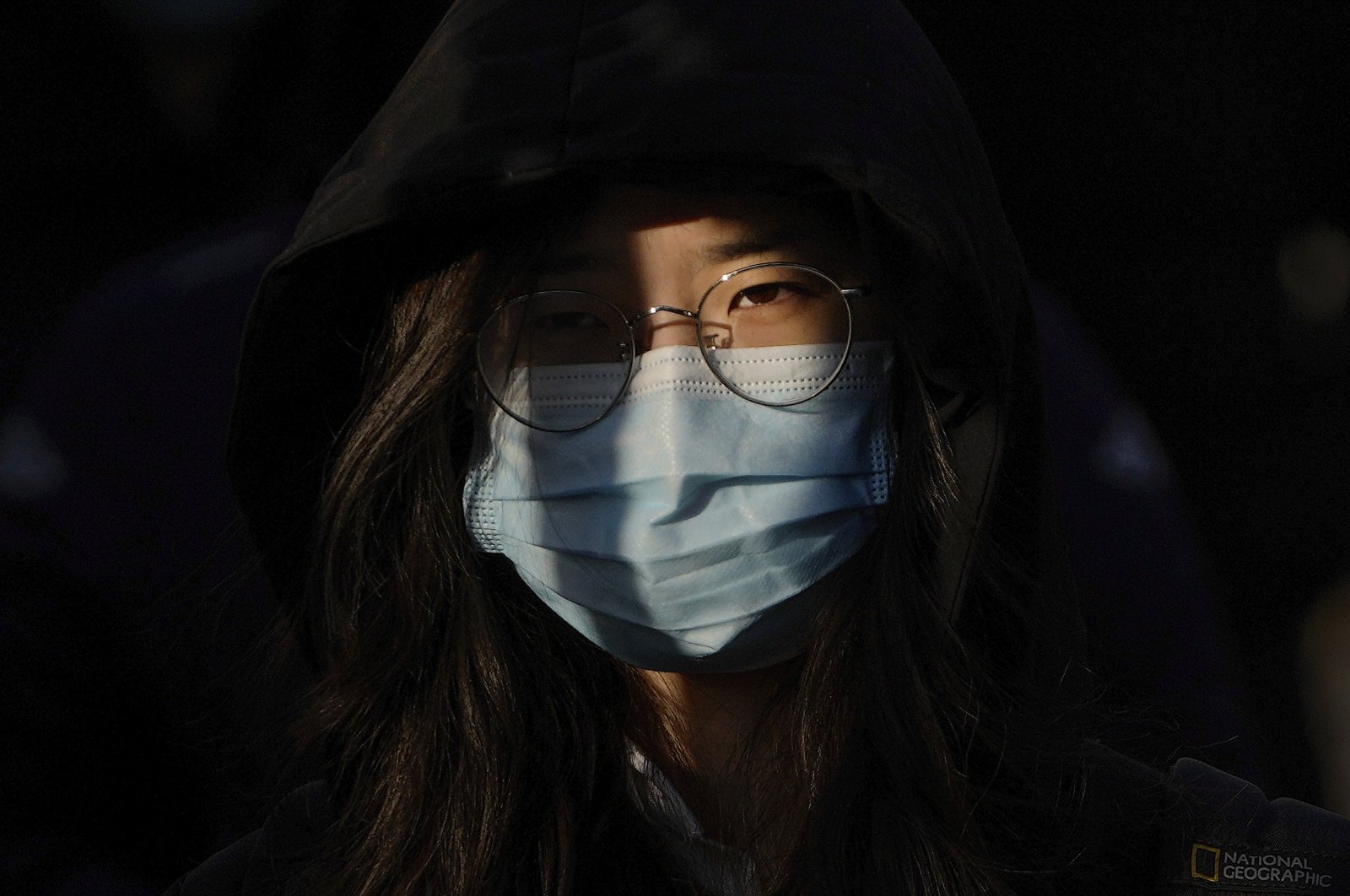 A woman wearing a face mask to protect from the coronavirus heads to work during the morning rush hour in Beijing, China, Jan. 10, 2022. (AP Photo)