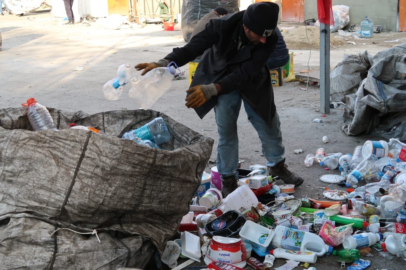 A trash collector sorts the items he collected, in Istanbul, Turkey, Jan. 10, 2022. (Photo by Saffet Azak)