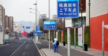 A volunteer walks outside the Main Press Center ahead of the Beijing 2022 Winter Olympics, China, Jan. 11, 2022. (Reuters Photo)