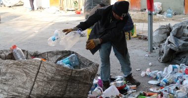 A trash collector sorts the items he collected, in Istanbul, Turkey, Jan. 10, 2022. (Photo by Saffet Azak)