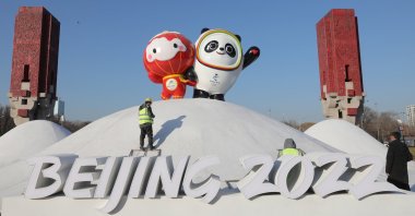 Chinese workers spray paint near the Bing Dwen Dwen, the Beijing 2022 Winter Olympic Mascot and Shuey Rhon Rhon, the 2022 Beijing Winter Paralympic Games Mascot, in Beijing, China, Jan. 11, 2022. (EPA Photo)
