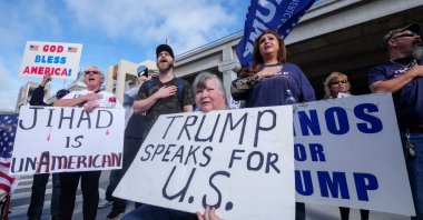 A group of Former U.S. President Donald Trump supporters display Islamophobic messages at a gathering (Reuters File Photo)
