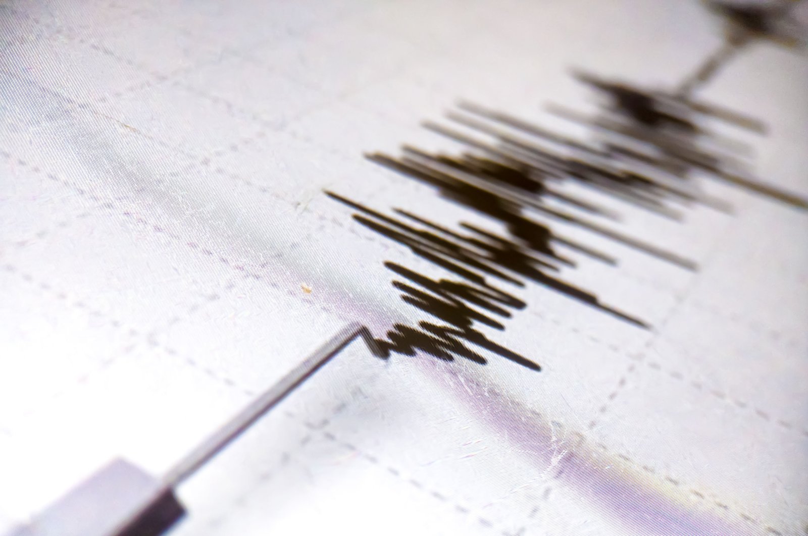 A seismometer printing line records earthquake tremors on white paper, Aceh, Indonesia. (Shutterstock Photo)