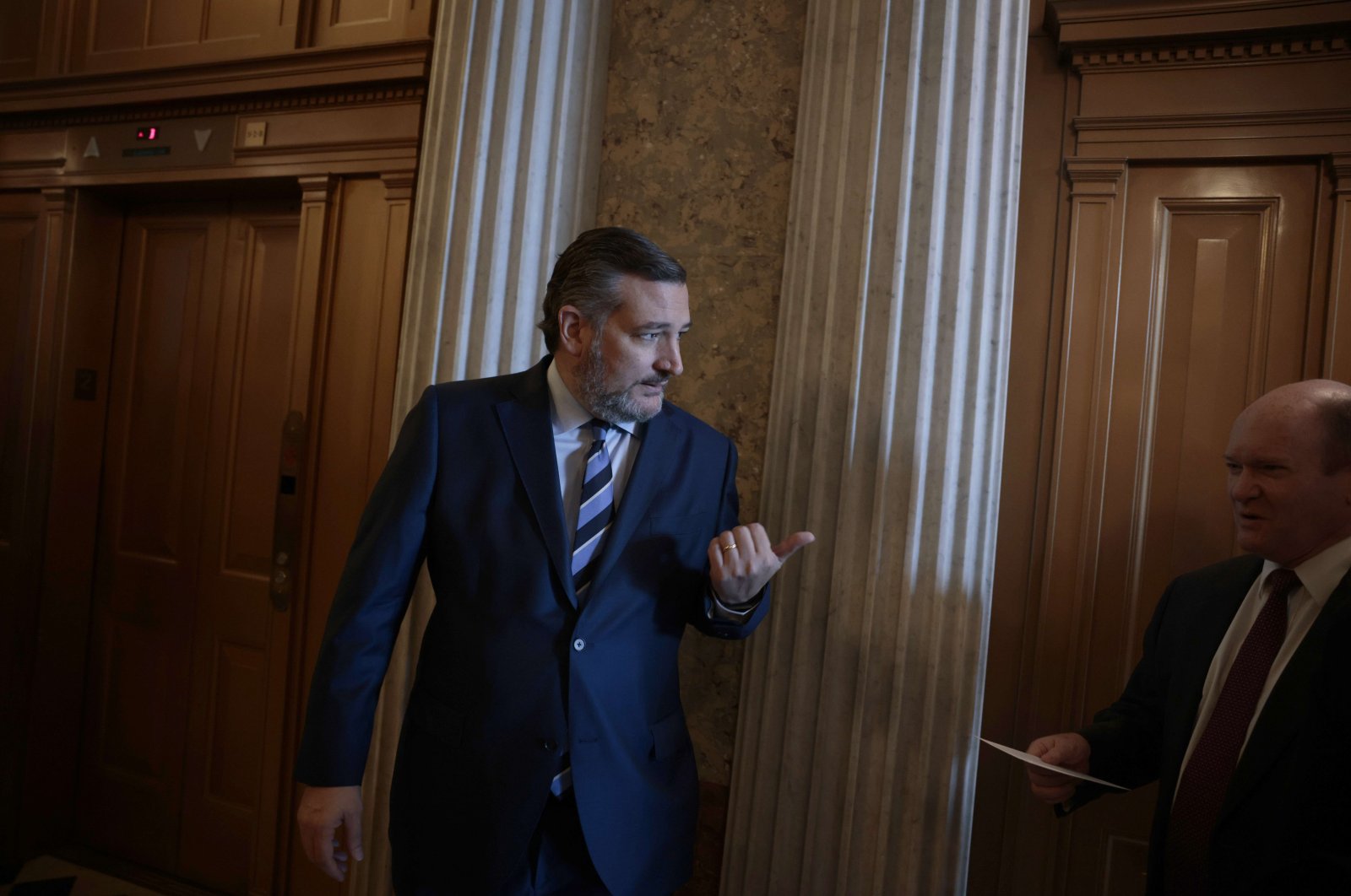 Sen. Ted Cruz (R-TX) speaks to Sen. Chris Coons (D-DE) as they walk to the Senate Chambers of the U.S. Capitol Building in Washington, D.C., U.S., Dec. 15, 2021. (AFP Photo)