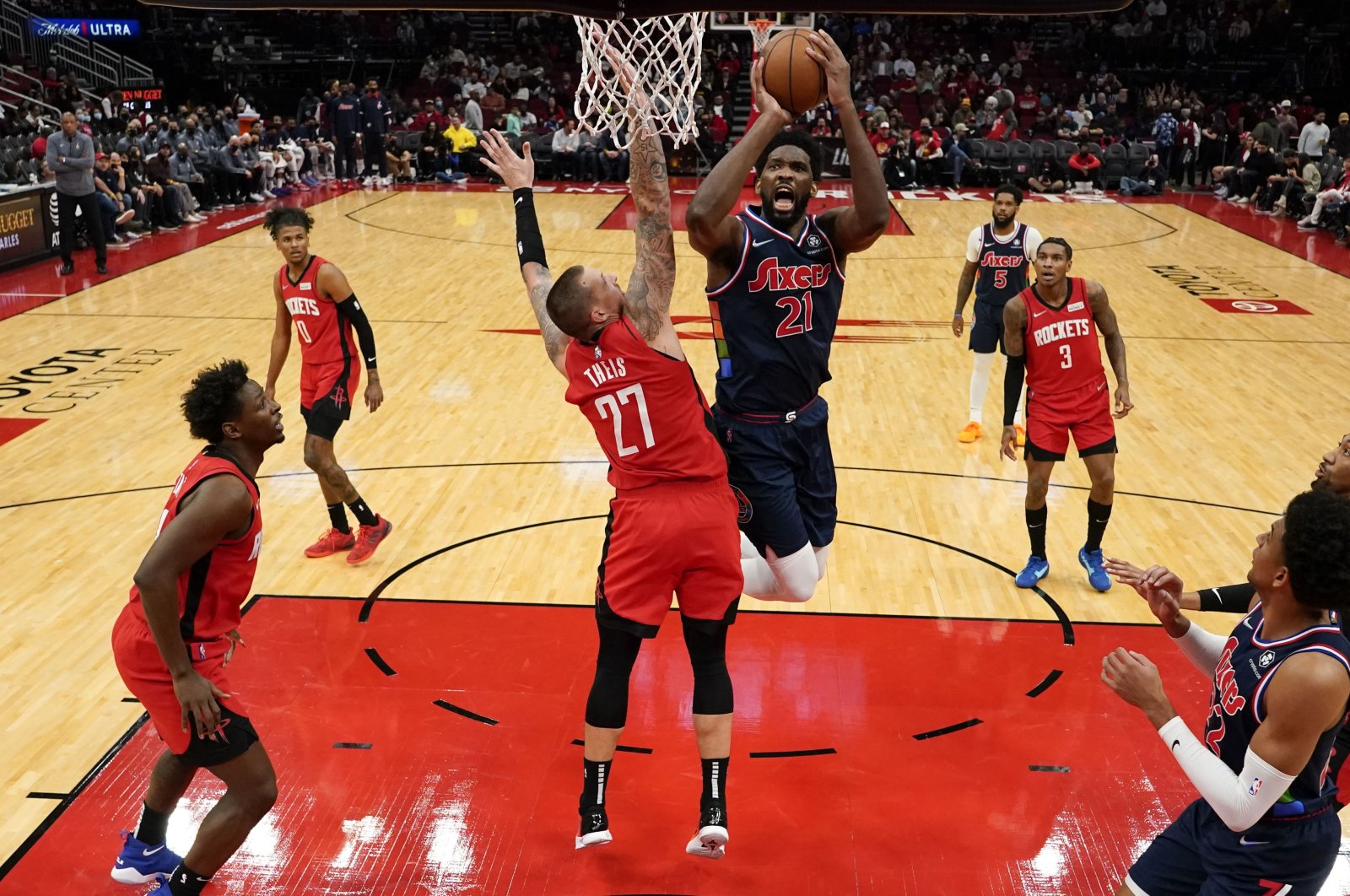 Philadelphia 76ers center Joel Embiid (3rd R) shoots as Houston Rockets center Daniel Theis (C) defends during an NBA game, Houston, U.S., Jan. 10, 2022. (AP Photo)