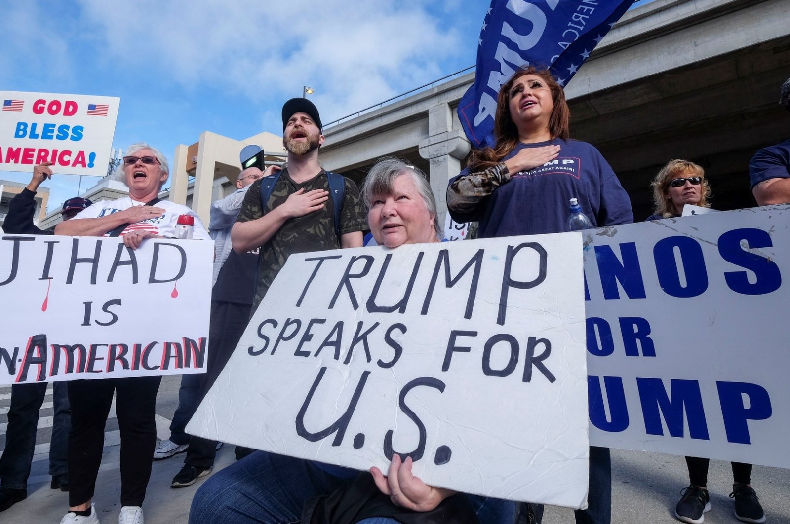 A group of Former U.S. President Donald Trump supporters display Islamophobic messages at a gathering (Reuters File Photo)