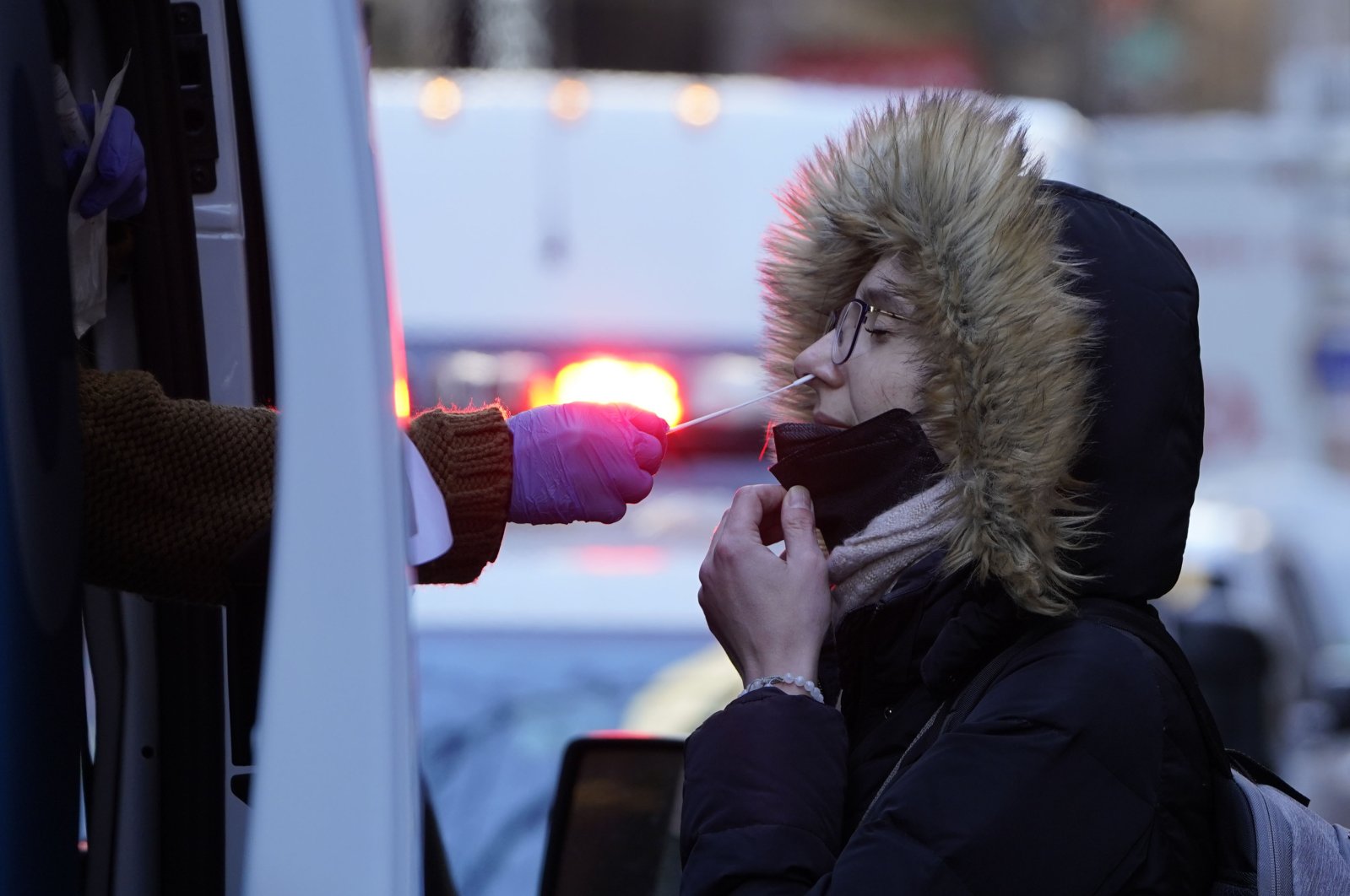A woman wearing a winter coat gets tested for COVID-19 at a mobile testing site in New York, U.S., Jan. 11, 2022.  (AP Photo/Seth Wenig)