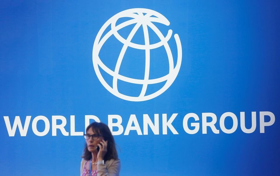 A participant stands near a logo of World Bank at the International Monetary Fund – World Bank Annual Meeting 2018 in Nusa Dua, Bali, Indonesia, Oct. 12, 2018. (Reuters Photo)