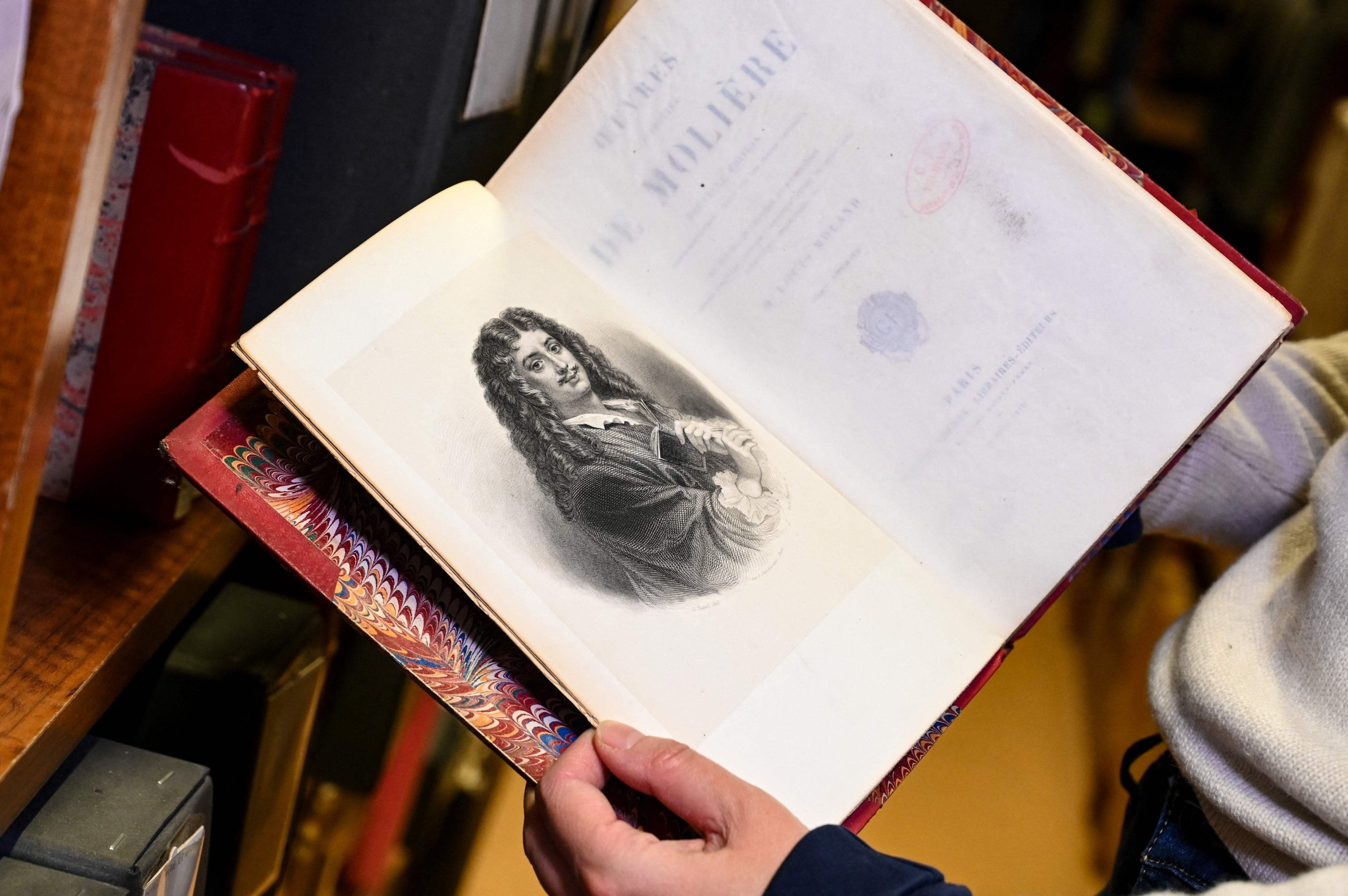 A page from an old anthology of plays by French playwright Moliere, at the Comedie Francaise library, in Paris, France, Dec. 14, 2021. (AFP Photo)