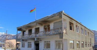 An Azeri national flag is seen on a house burned by departed Armenians, in an area later turned over to Azerbaijan, at the Kalbajar district, Azerbaijan, Dec. 21, 2020. (Reuters Photo)