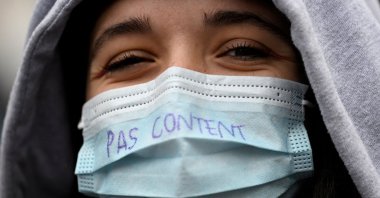 A health worker wears a face mask reading &quot;Not happy&quot; during a demonstration in support of the public hospital during a nationwide protest to ask for better working conditions and salary increases in Rennes, western France, Jan. 11, 2022. (AFP Photo)