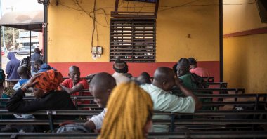 Travelers watch television while waiting for cross border transport to resume in Bamako, Mali on Jan. 11, 2022. (AFP Photo)