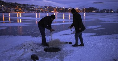Fishermen check the nets in Lake Çıldır, in Ardahan, eastern Turkey, Jan. 10, 2022. (PHOTO BY UĞUR YILDIRIM) 