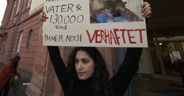 Serda Alshehabi comments on the verdict in front of the building of the Higher Regional Court in Koblenz, Germany, Feb. 24, 2021. (AP Photo)