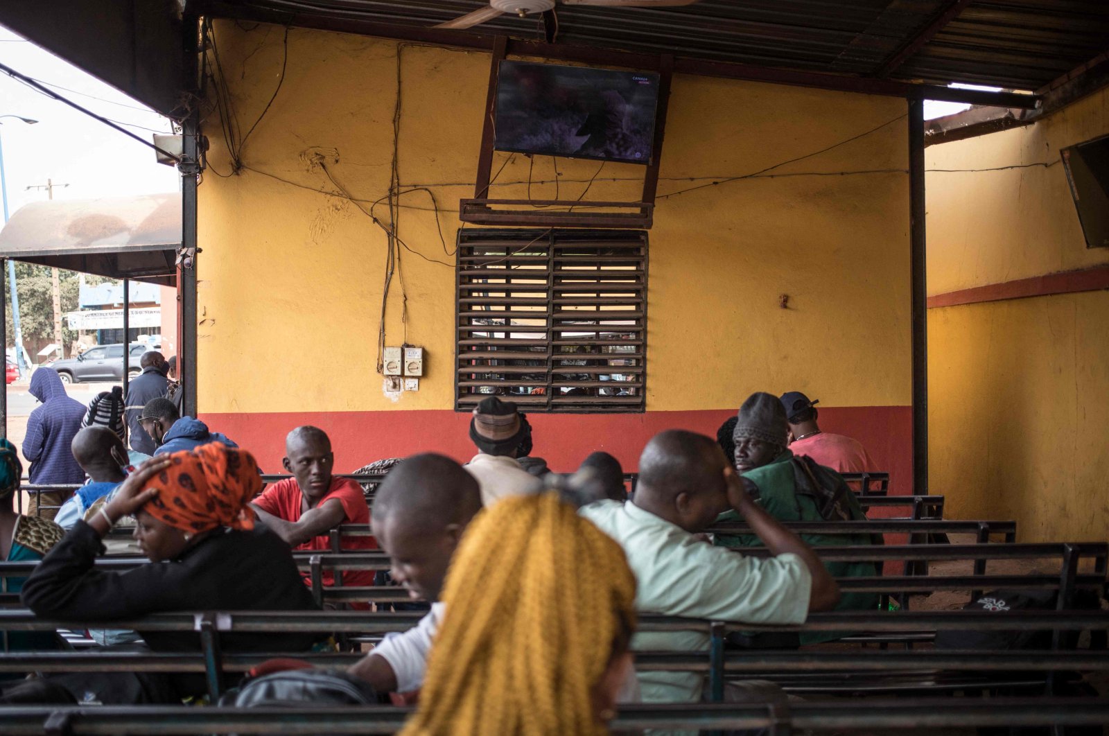 Travelers watch television while waiting for cross border transport to resume in Bamako, Mali on Jan. 11, 2022. (AFP Photo)