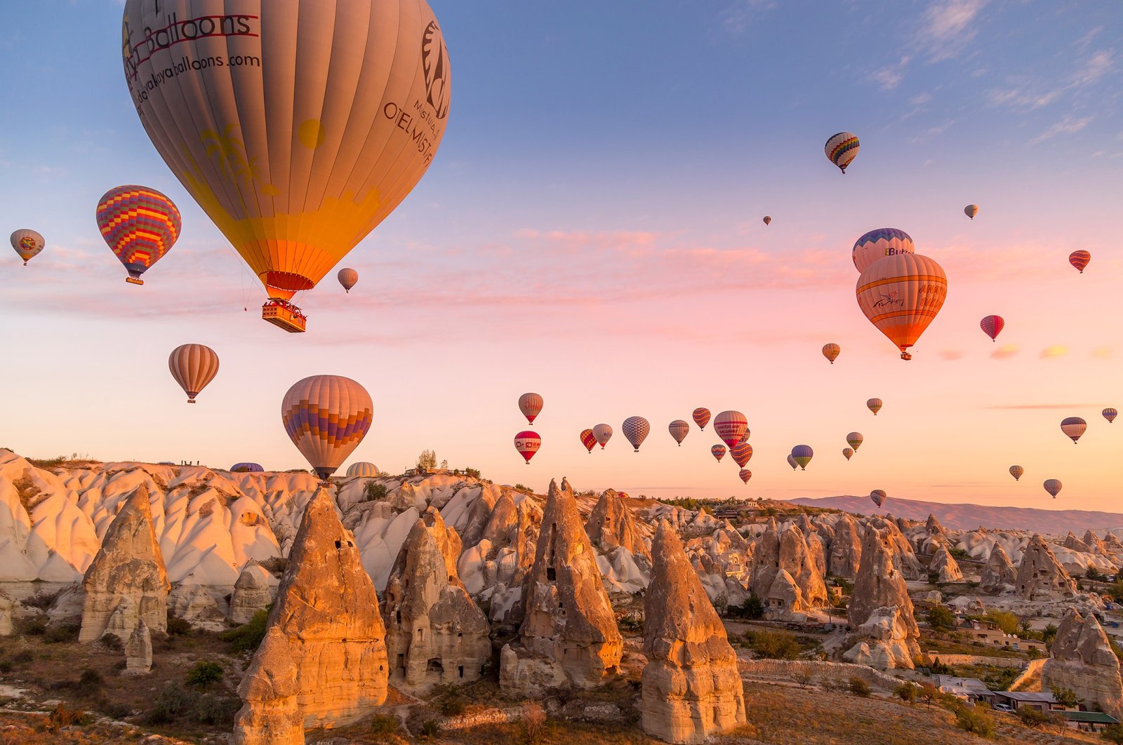Hot air balloons carrying tourists during a pink sunrise floating along the valleys of Göreme National Park, Turkey, Oct. 7, 2019. (Shutterstock Photo)