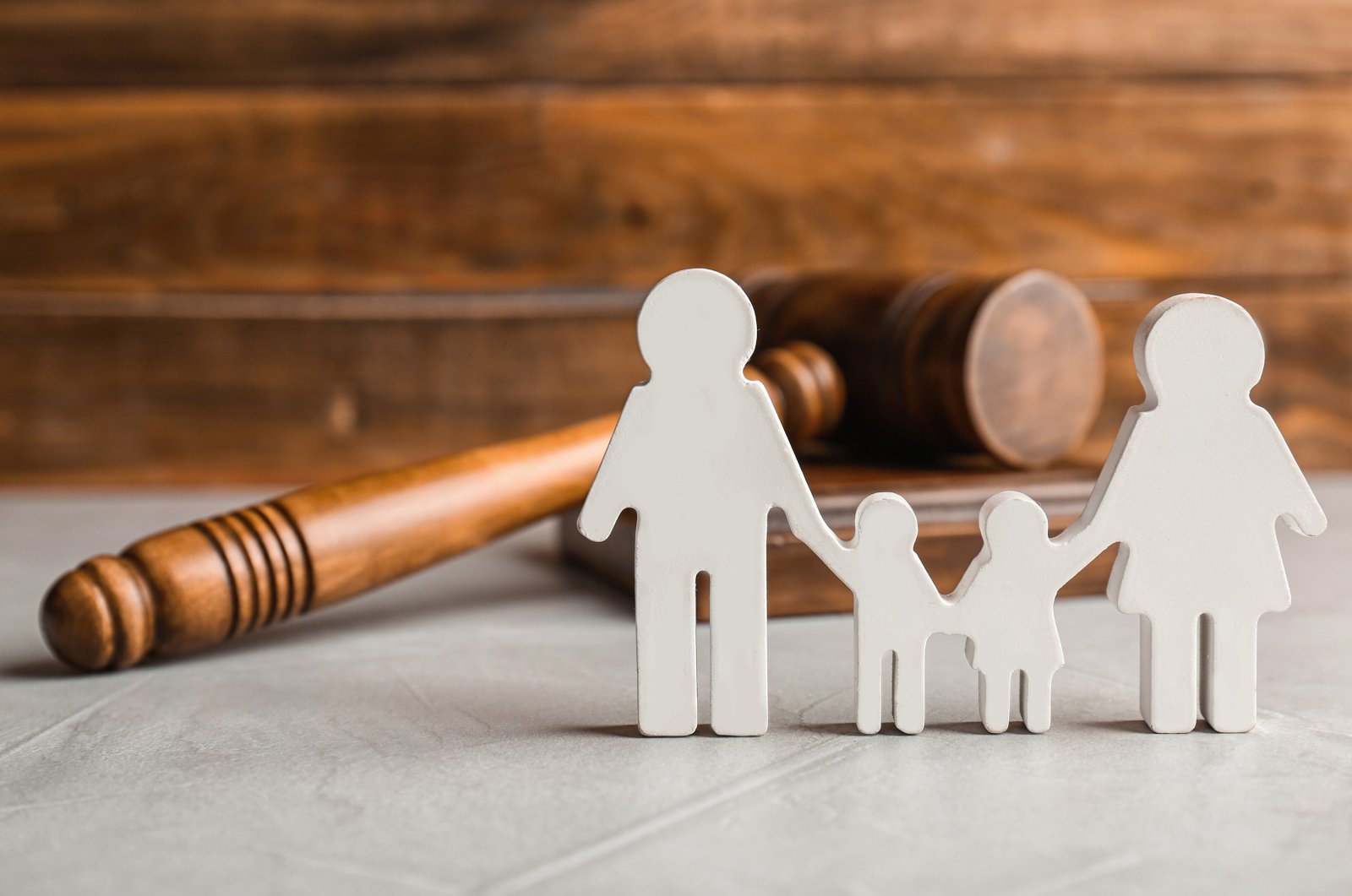 Family figurine and gavel on table (Shutterstock Photo)