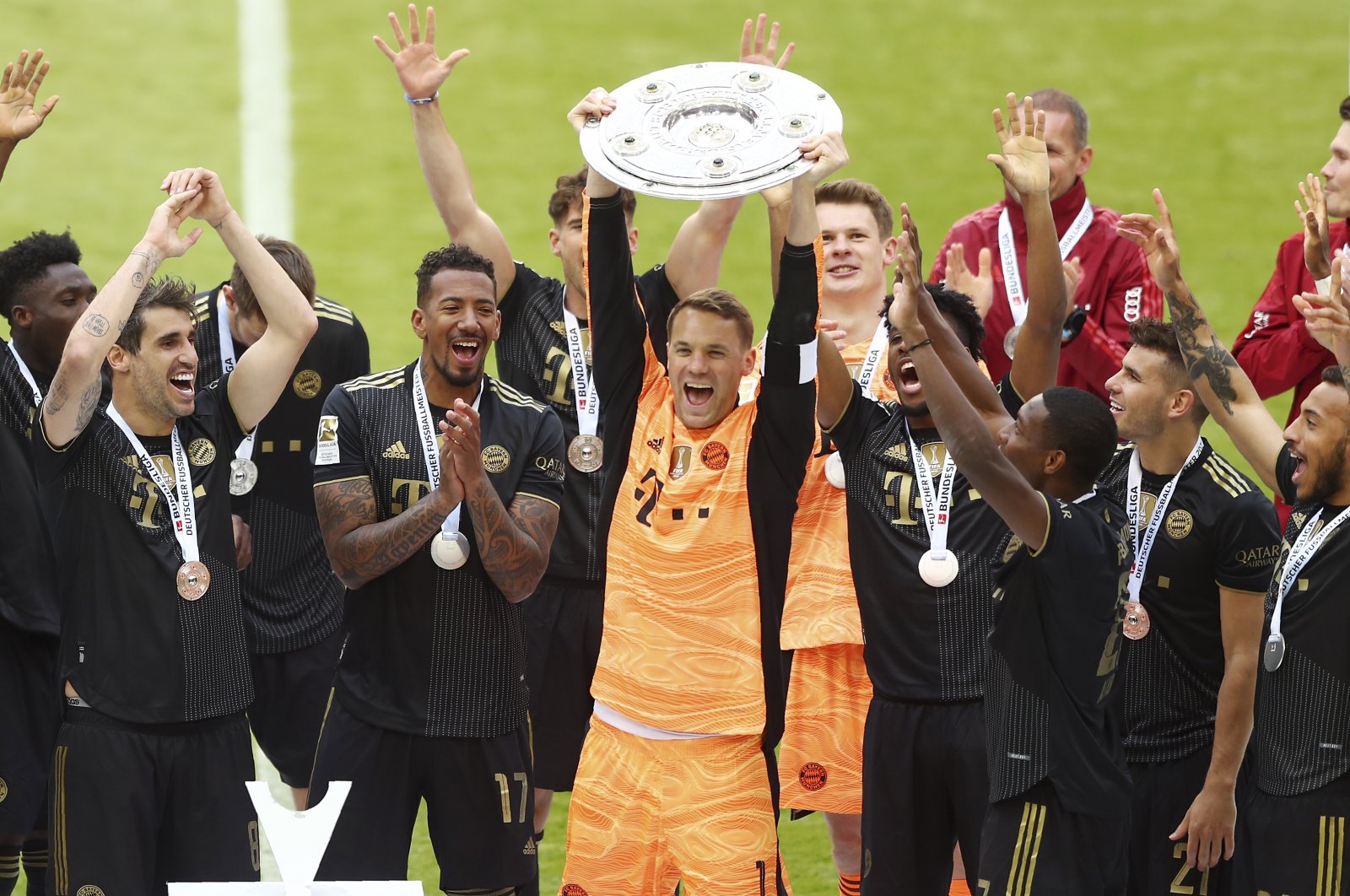 Bayern Munich captain Manuel Neuer lifts the Bundesliga title after a match against FC Augsburg, Munich, Germany, May 22, 2021. (AP Photo)