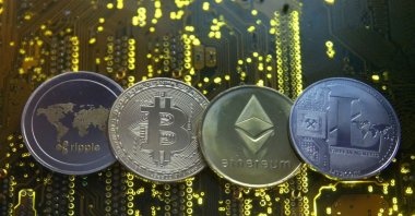 Representations of the Ripple, Bitcoin, Etherum and Litecoin virtual currencies are seen on a PC motherboard in this illustration picture, Feb. 14, 2018. (Illustration by Dado Ruvic via Reuters)