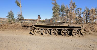 A boy sits on the barrel of a military tank destroyed recently during fighting between the Ethiopian National Defense Force (ENDF) and the Tigray People's Liberation Front (TPLF) forces in Damot Kebele of Amhara region, Ethiopia, Dec. 7, 2021. (Reuters Photo)