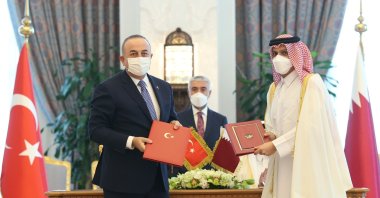 Foreign Minister Mevlüt Çavuşoğlu and his Qatari counterpart Sheikh Mohammad bin Abdulrahman Al Thani sign agreements during a meeting in Doha, Qatar, Dec. 8, 2021. (IHA File Photo)