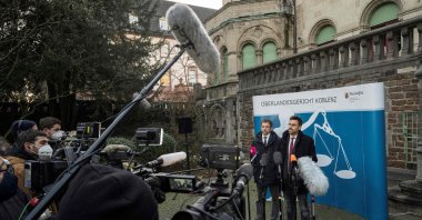 Rene Bahr and Patrick Kroker (R), lawyers of co-plaintiffs, address a press statement following the verdict in the trial of former Syrian intelligence officer Anwar Raslan outside the Higher Regional Court in Koblenz, western Germany, Jan. 13, 2022. (AFP Photo)