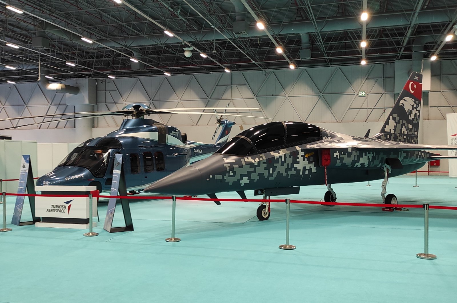 TAI&#039;s Gökbey multirole helicopter (L) and Hürjet light attack aircraft (R) showcased during defense fair SAHA EXPO 2021 held between Nov. 10-13 in Istanbul, Turkey. (IHA Photo)