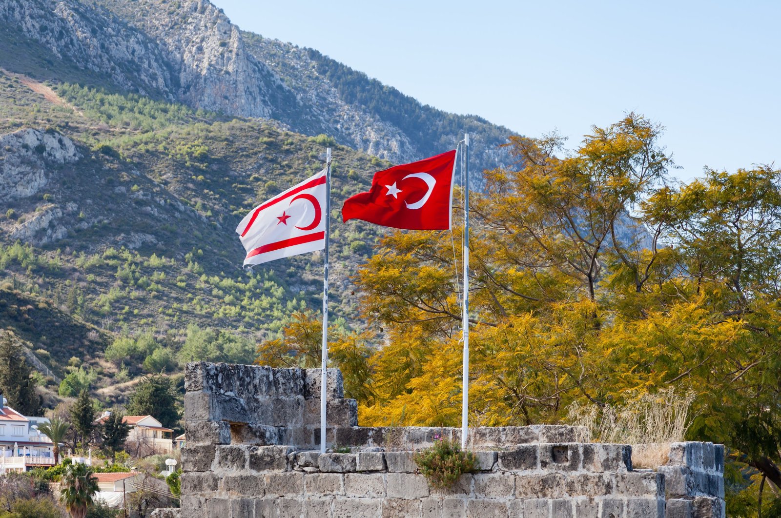 The flags of Turkey and the Turkish Republic of Northern Cyprus (TRNC) fly side by side at Bellapais Abbey in the TRNC, Jan. 27, 2016. (Photo by Shutterstock)