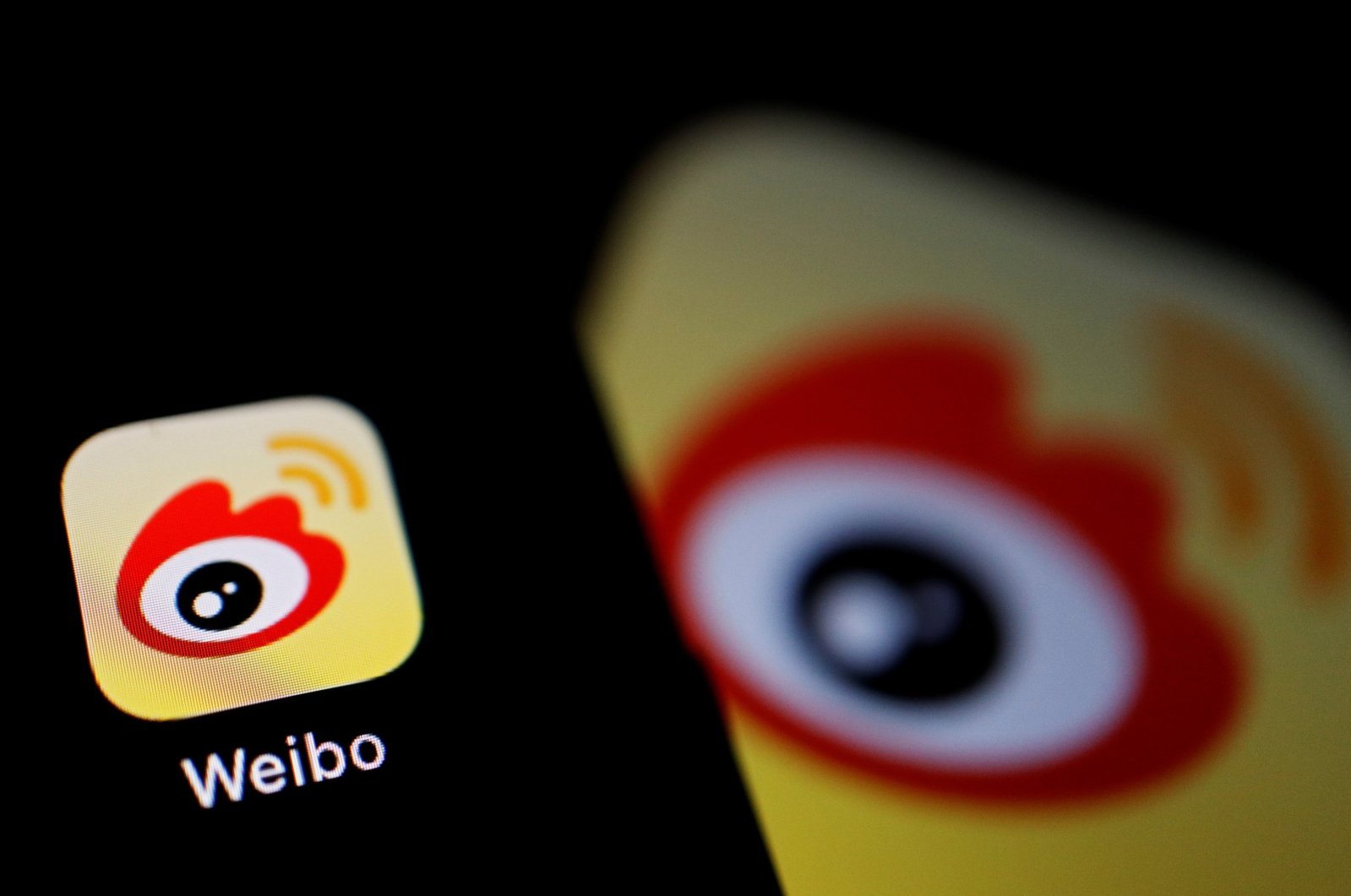 The logo of Chinese social media app Weibo is seen on a mobile phone in this illustration picture, Dec. 7, 2021. (Reuters Photo)