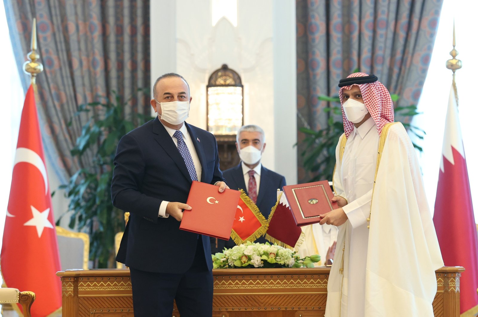 Foreign Minister Mevlüt Çavuşoğlu and his Qatari counterpart Sheikh Mohammad bin Abdulrahman Al Thani sign agreements during a meeting in Doha, Qatar, Dec. 8, 2021. (IHA File Photo)