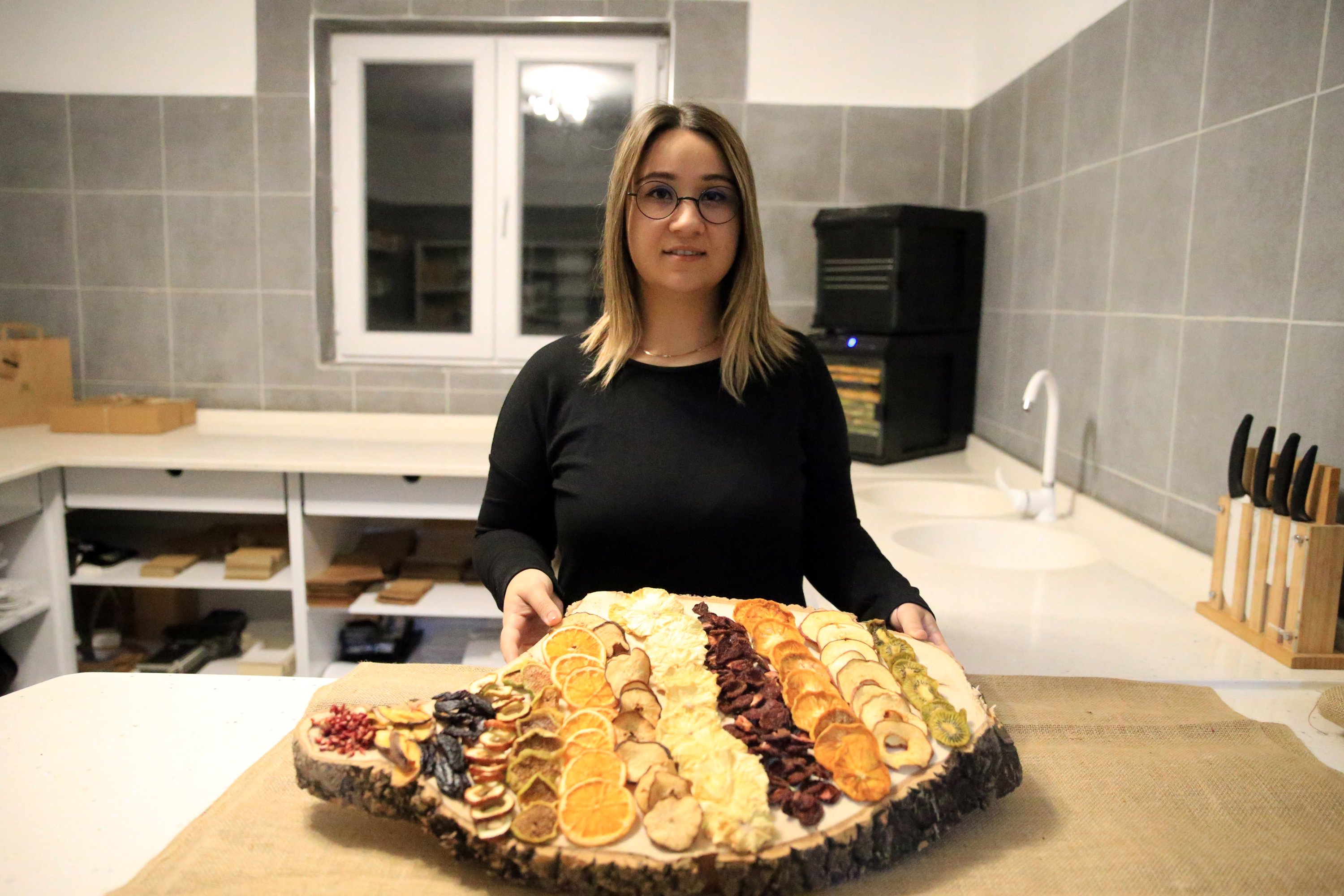 Woman entrepreneur Merve Anıl, who launched her business from home with two drying ovens, displays her dried fruits, Uşak, Turkey, Jan. 12, 2022. (AA Photo)