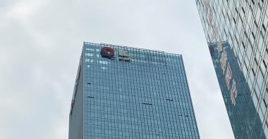 A partially removed company logo of China Evergrande Group is seen on the facade of its headquarters in Shenzhen, Guangdong province, China, Jan. 10, 2022. (Reuters Photo)