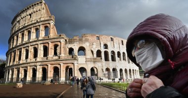 A man wearing a protective mask passes by the Colosseum amid the COVID-19 pandemic in Rome, Italy, March 7, 2020. (AFP Photo)